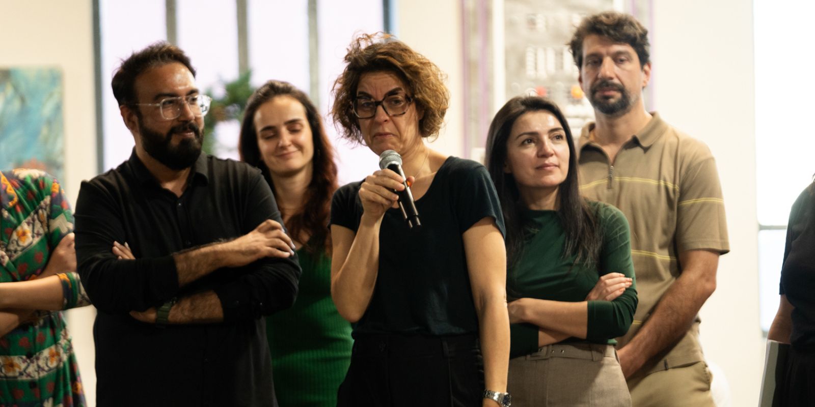 Confident senior female leader presenting to a group in a bright modern boardroom